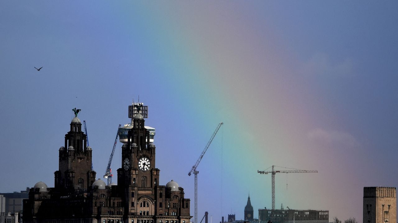 (FILES) In this file photo taken on March 06, 2019 a partial rainbow is pictured over the Royal Liver Building in Liverpool, north-west England. - Britain on July 21, 2021 expressed grave disappointment after the UN's cultural agency UNESCO voted to remove Liverpool from its list of world heritage sites because of overdevelopment. (Photo by Paul ELLIS / AFP)
