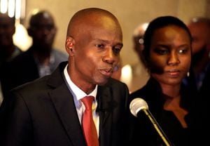 FILE PHOTO: Jovenel Moise addresses the media next to his wife Martine after winning the 2016 presidential election, in Port-au-Prince, Haiti. Picture taken November 28, 2016. REUTERS/Jeanty Junior Augustin/File Photo