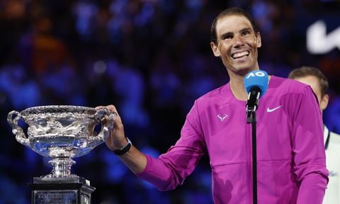 Rafael Nadal of Spain gestures with the Norman Brookes Challenge Cup after defeating Daniil Medvedev of Russia in the men's singles final at the Australian Open tennis championships in Melbourne, Australia, early Monday, Jan. 31, 2022. (AP/Hamish Blair)