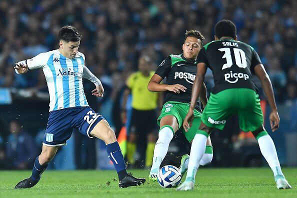 AVELLANEDA, ARGENTINA - AUGUST 10: Nicolás Oroz of Racing Club battles for possession with Juan Torres (C) and Jhon Solis (R) of Atletico Nacional during a Copa CONMEBOL Libertadores 2023 round of sixteen second leg match between Racing Club and Atletico Nacional at Presidente Peron Stadium on August 10, 2023 in Avellaneda, Argentina. (Photo by Marcelo Endelli/Getty Images)