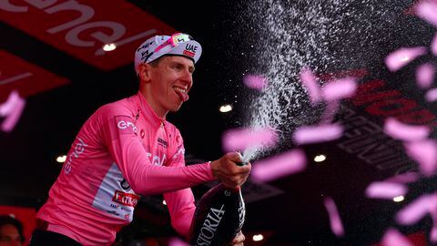 Team UAE's Slovenian rider Tadej Pogacar celebrates the overall leader's pink jersey on the podium of the 11th stage of the 107th Giro d'Italia cycling race, 207km between Foiano di Val Fortore and Franca Villa al Mare, on May 15, 2024. (Photo by Luca Bettini / AFP)
