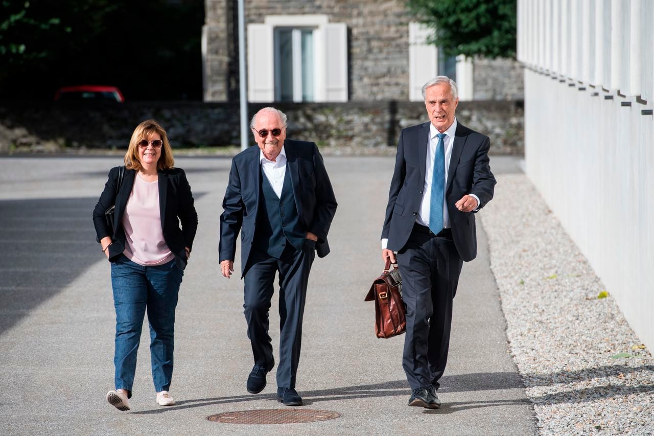 The former president of the World Football Association (Fifa), Joseph Blatter, center, accompanied by his daughter Corinne Blatter, left, and his lawyer Lorenz Erni, right, arrive at the Swiss Federal Criminal Court in Bellinzona, Switzerland, Wednesday, June 8, 2022. Blatter and the former president of the the European Football Association (UEFA), Michel Platini, will stand trial before the Federal Criminal Court from Wednesday, over a suspicious two-million payment. (Alessandro Crinari/Keystone via AP)