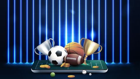 Champion cups and sport balls on smartphone in dark scene with wall of line vertical blue neon lamps on background.