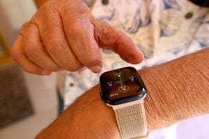 BAKERSFIELD, CA - JULY 17, 2023  Ken Mattlin, 86, adjusts his Apple watch at his home in Bakersfield on July 17, 2023.  Ken and his wife Audrey use robots and other devices for companionship and connectivity. Ken, a gadget freak, sees some pros along with the cons when using robots. Across the state, the aging department is awarding grants for technological aids that can help seniors stay tuned in and connected to each other. (Genaro Molina/Los Angeles Times via Getty Images)