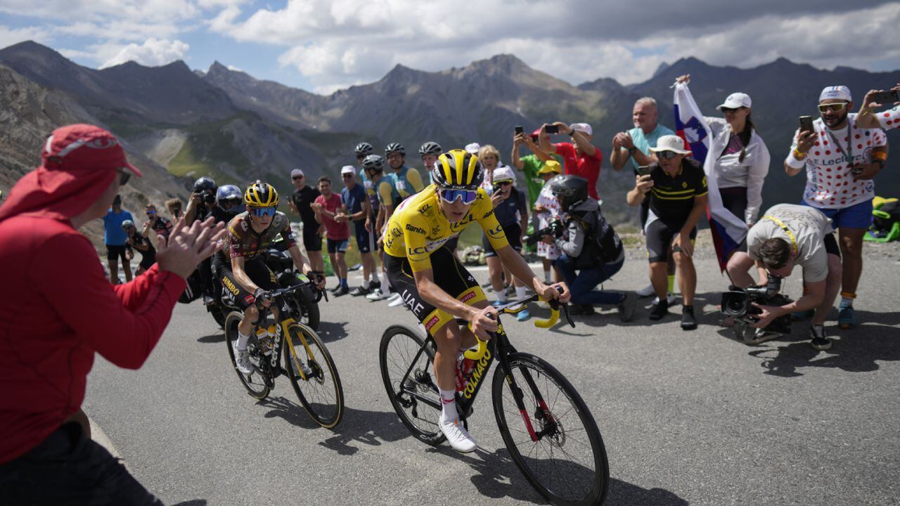 Stage winner and new overall leader Denmark's Jonas Vingegaard, left, and Slovenia's Tadej Pogacar, wearing the overall leader's yellow jersey, climb during the eleventh stage of the Tour de France cycling race over 152 kilometers (94.4 miles) with start in Albertville and finish in Col du Granon Serre Chevalier, France, Wednesday, July 13, 2022. (AP Photo/Thibault Camus)