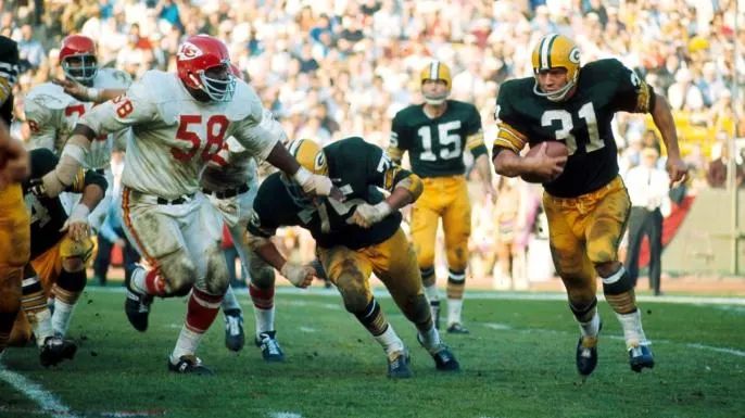 Green Bay Packers Hall of Fame fullback Jim Taylor turns the corner with Kansas City Chiefs defensive tackle Andrew Rice trying to catch. 

Getty Images / James Flores