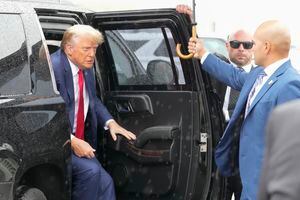 Former President Donald Trump arrives to board his plane at Ronald Reagan Washington National Airport, Thursday, Aug. 3, 2023, in Arlington, Va., after facing a judge on federal conspiracy charges that allege he conspired to subvert the 2020 election. At right is valet Walt Nauta. (AP Photo/Alex Brandon)