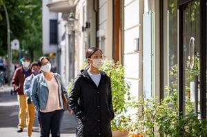 Group of people waiting in the queue outside a store maintaining social distancing. People with face mask standing in line with social distancing outside a store.