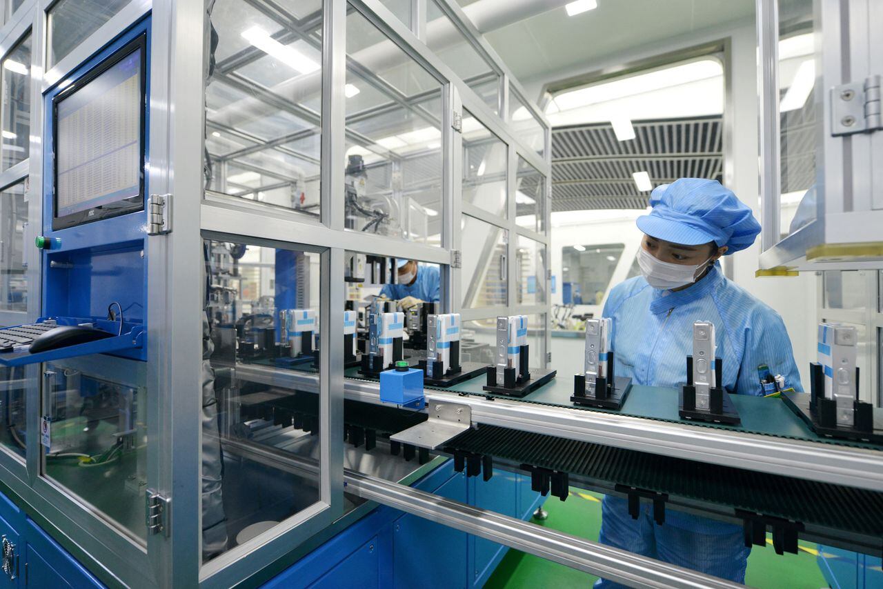 Los trabajadores son vistos en la línea de producción de baterías de iones de litio para vehículos eléctricos (EV) en una fábrica en Huzhou, provincia de Zhejiang, China