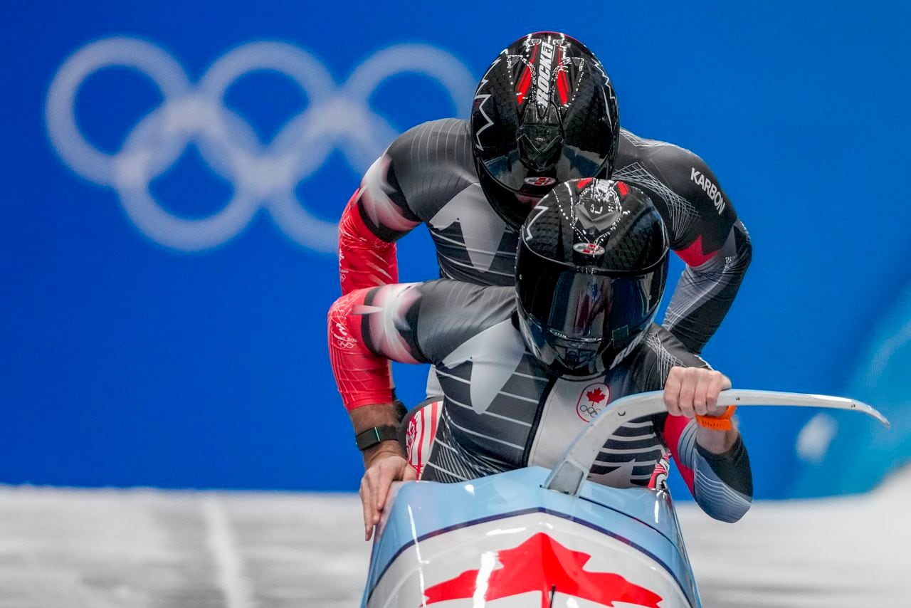 Justin Kripps and Cam Stones, of Canada, start the 2-man heat 1 at the 2022 Winter Olympics, Monday, Feb. 14, 2022, in the Yanqing district of Beijing. (AP Photo/Pavel Golovkin)
