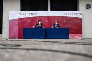 Tokyo 2020 Olympic Games CEO Toshiro Muto (R) speaks during a press conference following a Tokyo 2020 Olympics Executive Board meeting in Tokyo on December 22, 2020. (Photo by Carl Court / POOL / AFP)