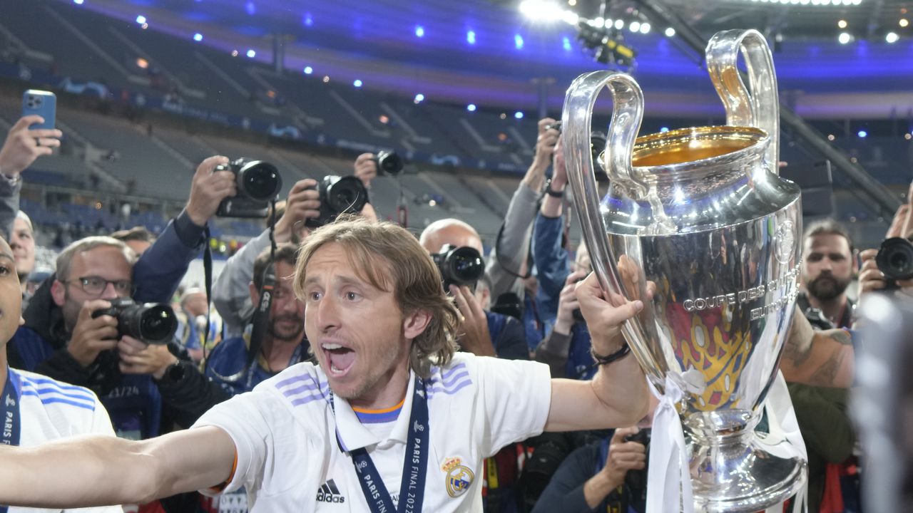 Real Madrid's Luka Modric holds the trophy after winning the Champions League final soccer match between Liverpool and Real Madrid at the Stade de France in Saint Denis near Paris, Sunday, May 29, 2022. (AP Photo/Kirsty Wigglesworth)