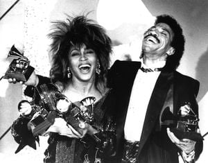 FILE - Tina Turner, left, and Lionel Richie pose with a total of five awards between them, at the Grammy Awards show in Los Angeles on Feb. 27, 1985. Turner, the unstoppable singer and stage performer, died Tuesday, after a long illness at her home in Küsnacht near Zurich, Switzerland, according to her manager. She was 83. (AP Photo/Lennox McLendon, File)