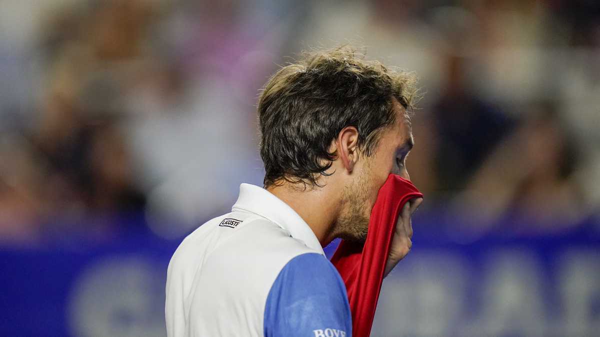 Russia's Daniil Medvedev wipes off sweat as he plays against Spain's Rafael Nadal in a semifinal match at the Mexican Open tennis tournament in Acapulco, Mexico, Friday, Feb. 25, 2022. (AP Photo/Eduardo Verdugo)