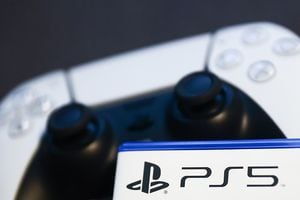 PlayStation 5 game packaging and PlayStation DualSense controller in the background are seen in this illustration photo taken in Krakow, Poland on April 9, 2022. (Photo by Jakub Porzycki/NurPhoto via Getty Images)