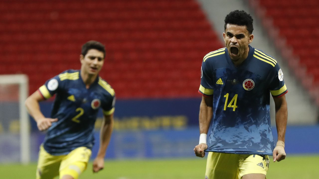 Colombia's Luis Diaz, right, celebrates scoring his side's third goal against Peru during a Copa America third place soccer match at the National stadium in Brasilia, Brazil, Friday, July 9, 2021. (AP Photo/Andre Penner)