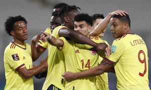 Colombia's Luis Diaz (14) celebrates scoring his side's third goal against Peru during a qualifying soccer match for the FIFA World Cup Qatar 2022 at the National stadium in Lima, Peru, Thursday, June 3, 2021. (Paolo Aguilar/Pool via AP)