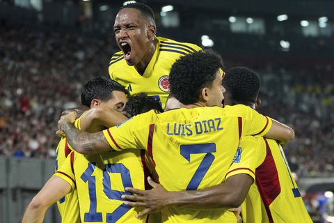 Teammates celebrate with Colombia's Rafael Santos Borre (19) after he scored his side's opening goal against Paraguay in a qualifying soccer match for the FIFA World Cup 2026 at Defensores del Chaco stadium in Asuncion, Paraguay, Tuesday, Nov. 21, 2023. (AP Photo/Jorge Saenz)