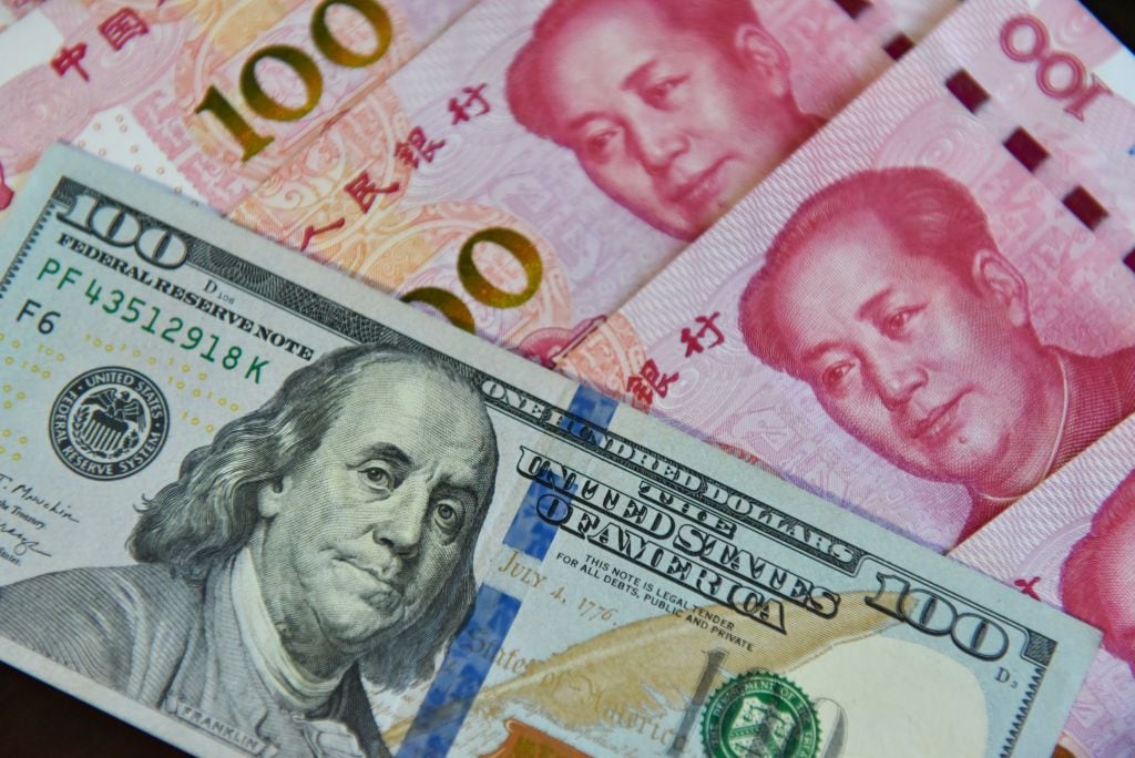 CHINA - 2023/08/29: In this photo illustration, a $100 bill and some 100 yuan are shown together. (Photo Illustration by Sheldon Cooper/SOPA Images/LightRocket via Getty Images)