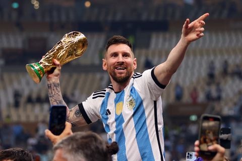LUSAIL CITY, QATAR - DECEMBER 18: Lionel Messi of Argentina celebrates with the World Cup Trophy during the FIFA World Cup Qatar 2022 Final match between Argentina and France at Lusail Stadium on December 18, 2022 in Lusail City, Qatar. (Photo by Marc Atkins/Getty Images)