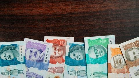 colombian money of different denominations in a wooden background