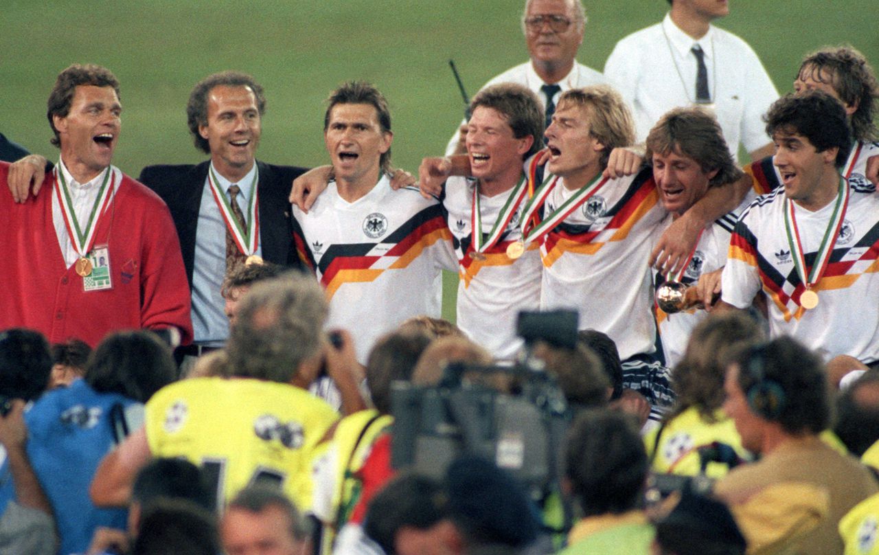 FILED - 08 July 1990, Italy, Rom: Franz Beckenbauer (2nd from left) celebrates winning the World Cup as coach of the German national soccer team in the Olympic Stadium in Rome, surrounded by his players. Germany had beaten Argentina 1:0 in the final. Franz Beckenbauer is dead. The German soccer legend died on Sunday at the age of 78, his family told the German Press Agency on Monday. Photo: Frank Kleefeldt/dpa (Photo by Frank Kleefeldt/picture alliance via Getty Images)