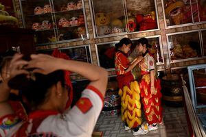 This photograph taken on January 20, 2021 shows female dancers getting ready for a practice session at the Tu Anh Duong lion and dragon dance school in Can Tho city in southern Vietnam's Mekong Delta.