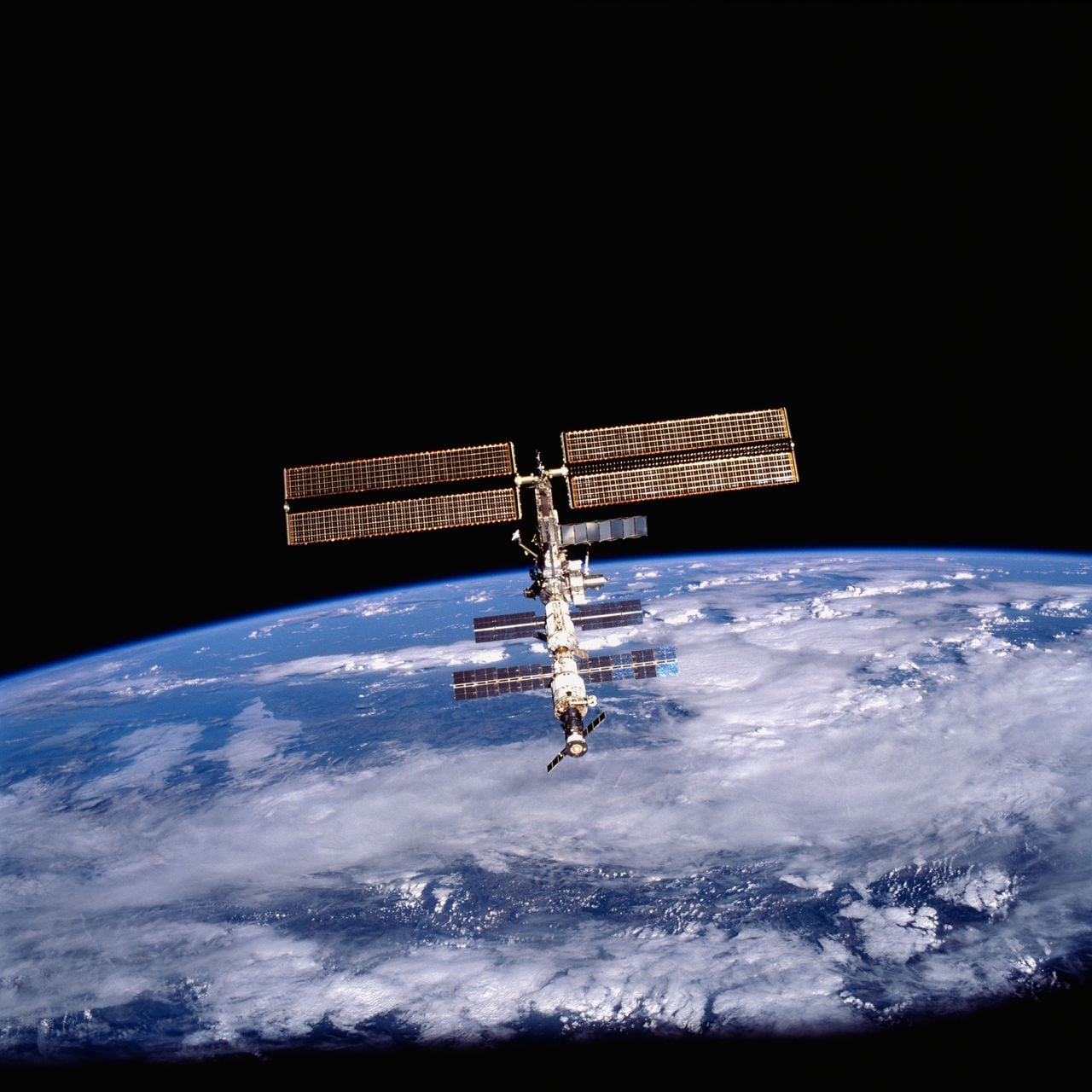 This image of the International Space Station (ISS) was photographed by one of the crewmembers of the STS-105 mission from the Shuttle Orbiter Discovery after separating from the ISS. The STS-105 mission was the 11th ISS assembly flight and its goals were the rotation of the ISS Expedition Two crew with Expedition Three crew, and the delivery of supplies utilizing the Italian-built Multipurpose Logistic Module (MPLM) Leonardo. Aboard Leonardo were six resupply stowage racks, four resupply stowage supply platforms, and two new scientific experiment racks, EXPRESS (Expedite the Processing of Experiments to the Space Station) Racks 4 and 5, which added science capabilities to the ISS. Another payload was the Materials International Space Station Experiment (MISSE), which included materials and other types of space exposure experiments mounted on the exterior of the ISS.