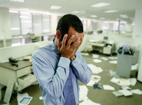 Stressed Businessman in Messy Office