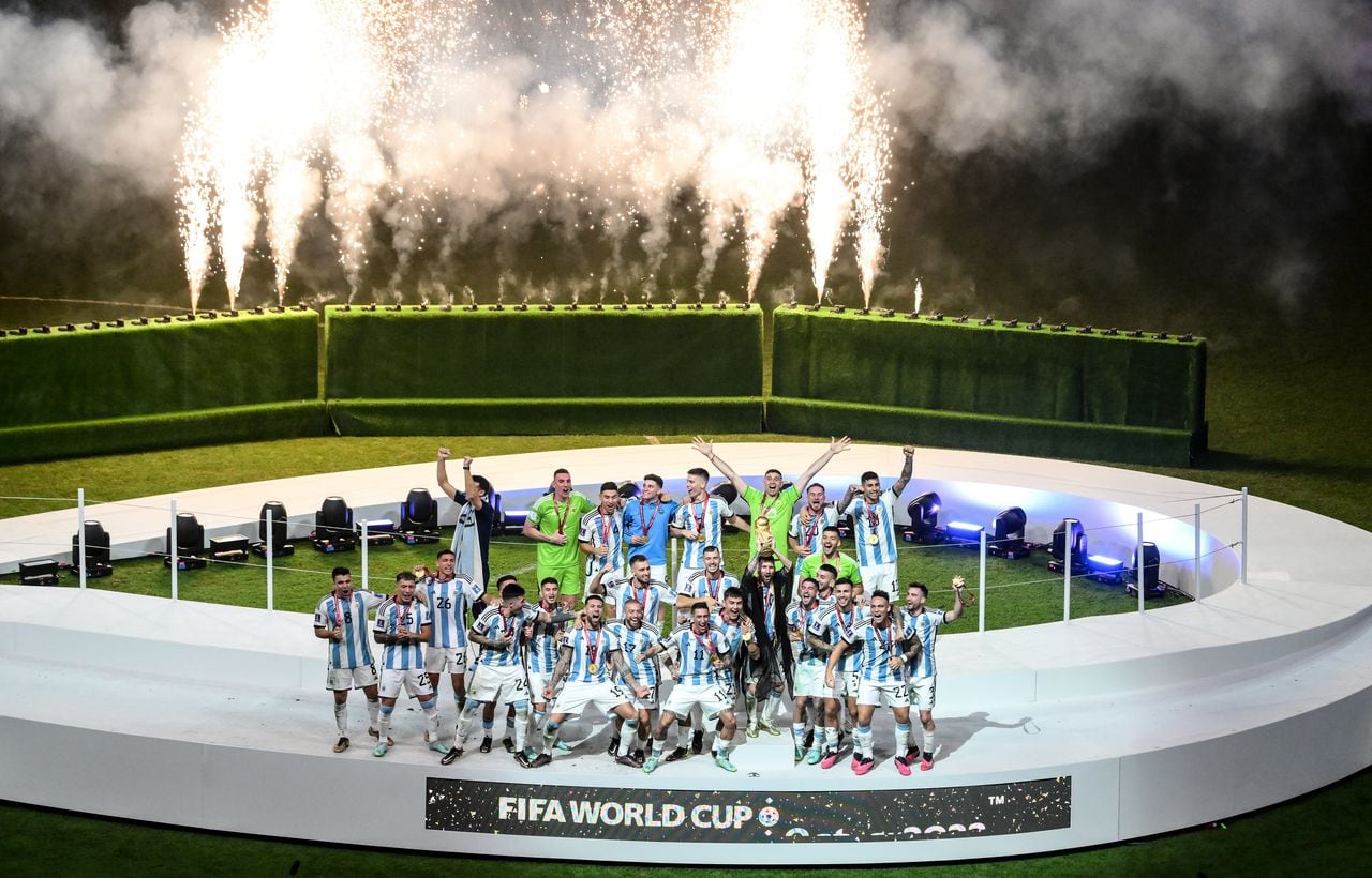 LUSAIL CITY, QATAR - DECEMBER 18: Argentina players celebrate with the FIFA World Cup trophy following the FIFA World Cup Qatar 2022 Final match between Argentina and France at Lusail Stadium on December 18, 2022 in Lusail City, Qatar. (Photo by Stephen McCarthy - FIFA/FIFA via Getty Images)