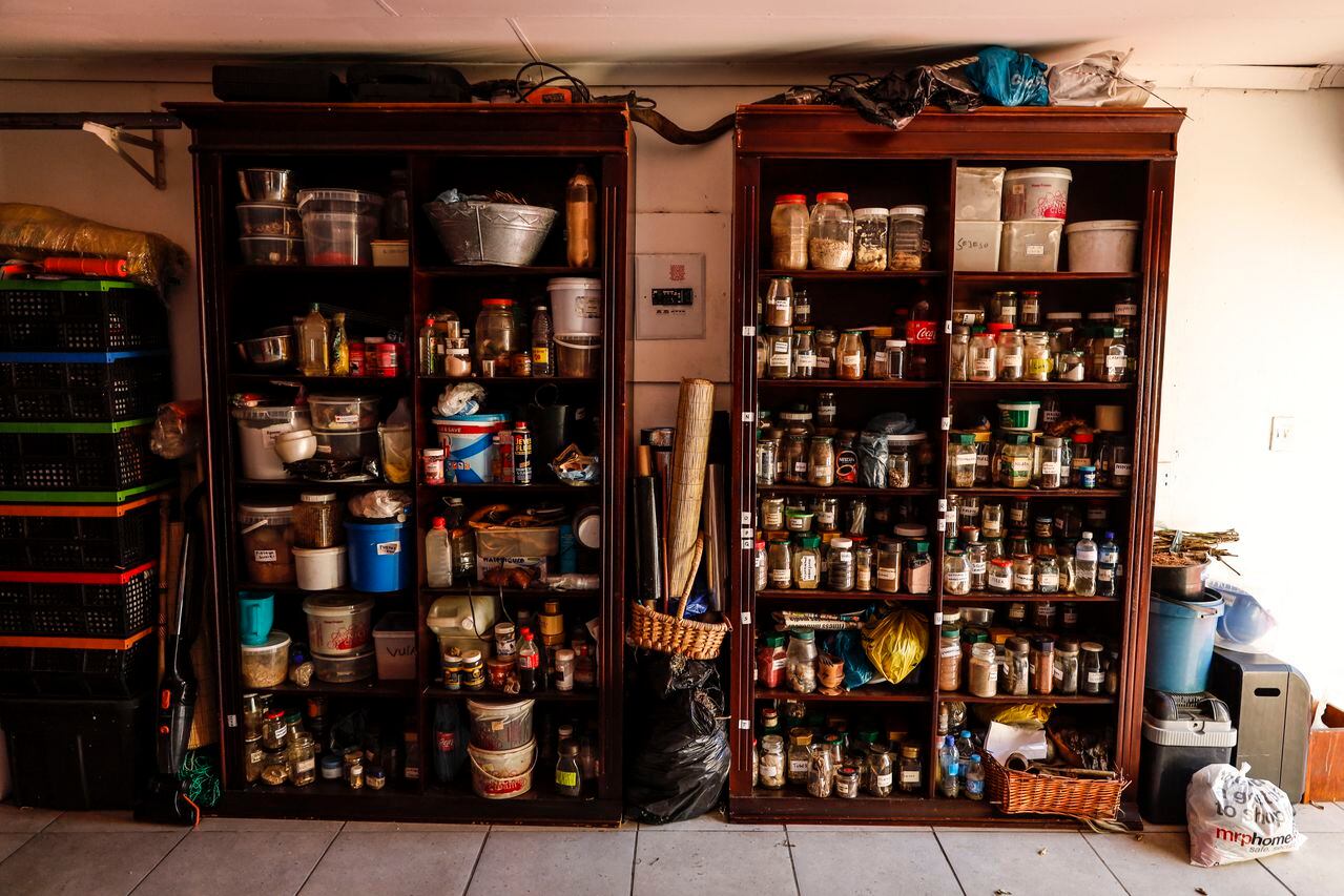 Shelves with jars containing herbs and other ingredients to make traditional remedies can be seen at the garage of a traditional healer in Kempton Park, South Africa on April 16, 2021. - Known as "sangomas" in Zulu language, traditional healers are qualified herbalists, councillors and community mediators as well as diviners.