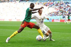 Soccer Football - FIFA World Cup Qatar 2022 - Group G - Cameroon v Serbia - Al Janoub Stadium, Al Wakrah, Qatar - November 28, 2022 Cameroon's Nicolas Nkoulou fouls Serbia's Andrija Zivkovic and subsequently receives a yellow card REUTERS/Hannah Mckay