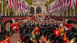 The coffin of Queen Elizabeth II is carried following her funeral service in Westminster Abbey in central London, Monday, Sept. 19, 2022. The Queen, who died aged 96 on Sept. 8, will be buried at Windsor alongside her late husband, Prince Philip, who died last year. (AP Photo/Vadim Ghirda, Pool)