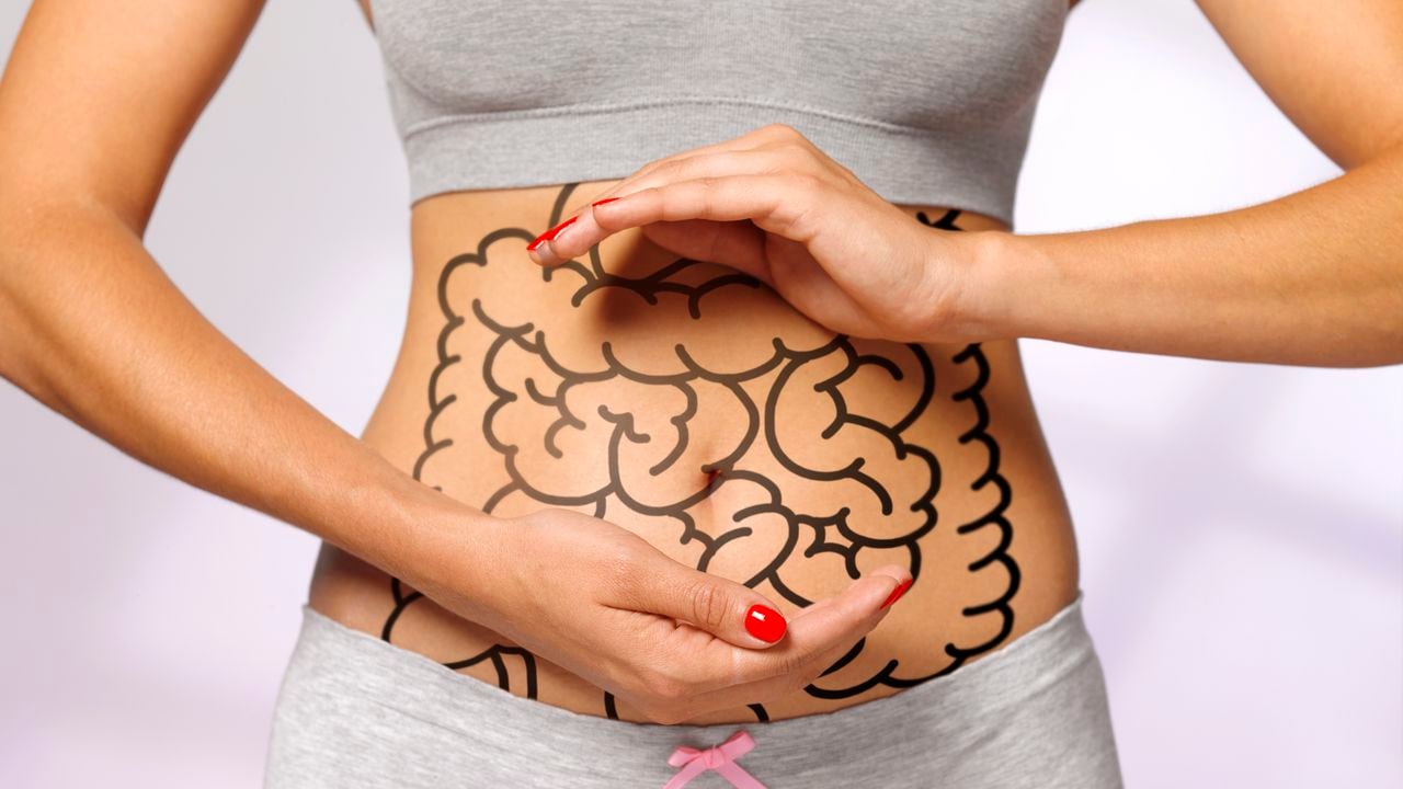women cradling her internal organs / intestines