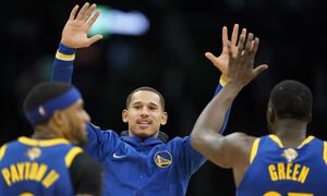 Golden State Warriors forward Juan Toscano-Anderson (95) high fives forward Draymond Green (23) and guard Gary Payton II (0) during the second quarter of Game 6 of basketball's NBA Finals against the Boston Celtics, Thursday, June 16, 2022, in Boston. (AP Photo/Steven Senne)