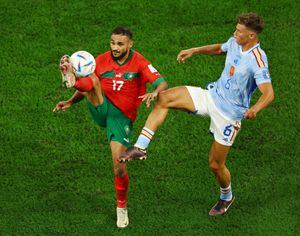 Soccer Football - FIFA World Cup Qatar 2022 - Round of 16 - Morocco v Spain - Education City Stadium, Al Rayyan, Qatar - December 6, 2022 Morocco's Sofiane Boufal in action with Spain's Marcos Llorente REUTERS/Lee Smith