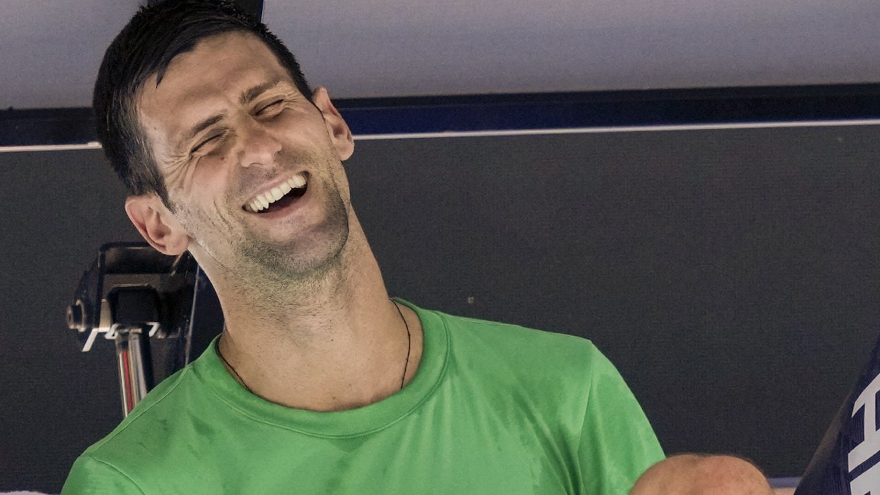 Defending men's champion Serbia's Novak Djokovic laughs as he rests during a practice session on Margaret Court Arena ahead of the Australian Open tennis championship in Melbourne, Australia, Thursday, Jan. 13, 2022. AP /Mark Baker)