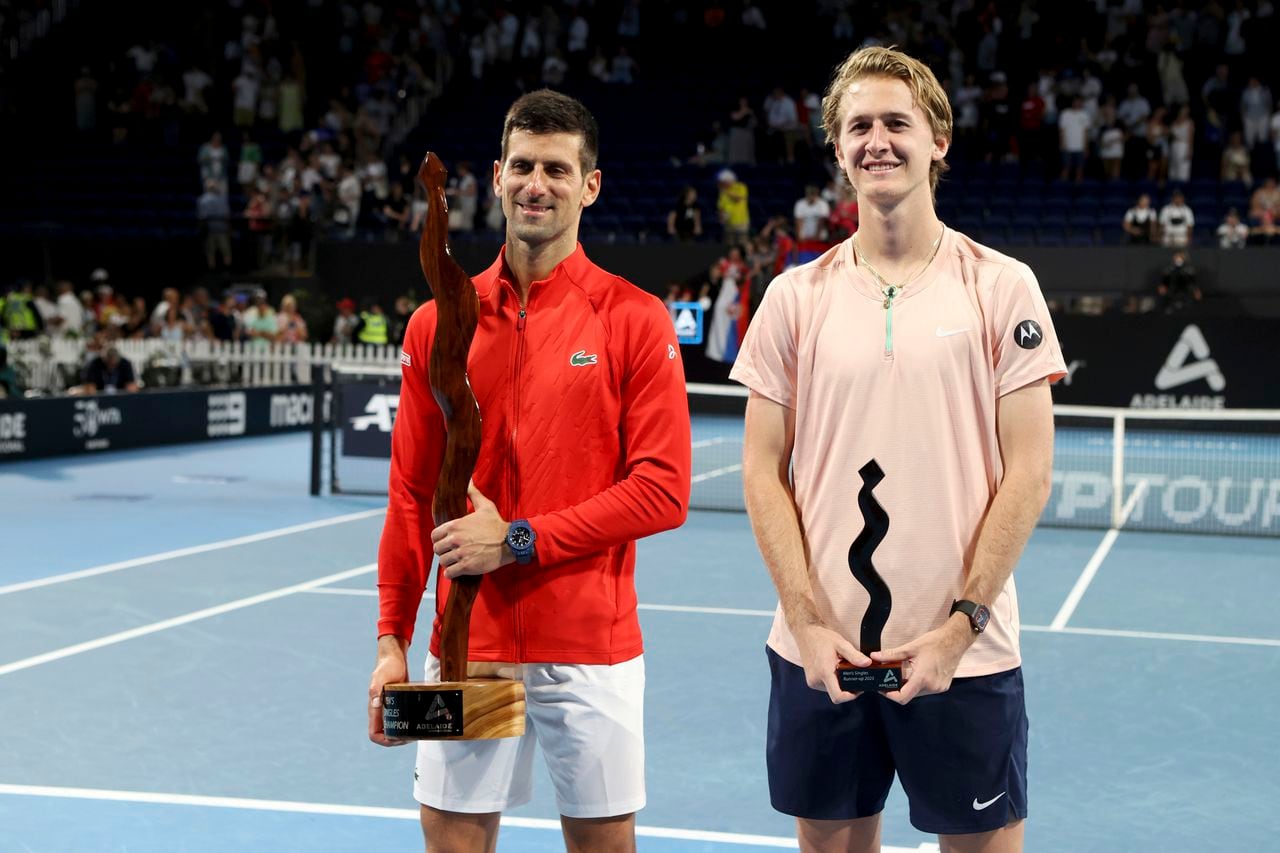 Winner Serbia's Novak Djokovic and runner-up USA's Sebastian Korda pose for a photo after the final of the Adelaide International tennis tournament in Adelaide, Australia, Sunday, Jan. 8, 2023. (AP Photo/Kelly Barnes)