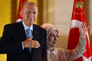 Turkish President and People's Alliance's presidential candidate Recep Tayyip Erdogan, left, and his wife, Emine, gesture to supporters at the presidential palace, in Ankara, Turkey, Sunday, May 28, 2023. Turkey President Recep Tayyip Erdogan won reelection Sunday, extending his increasingly authoritarian rule into a third decade as the country reels from high inflation and the aftermath of an earthquake that leveled entire cities. (AP Photo/Ali Unal)