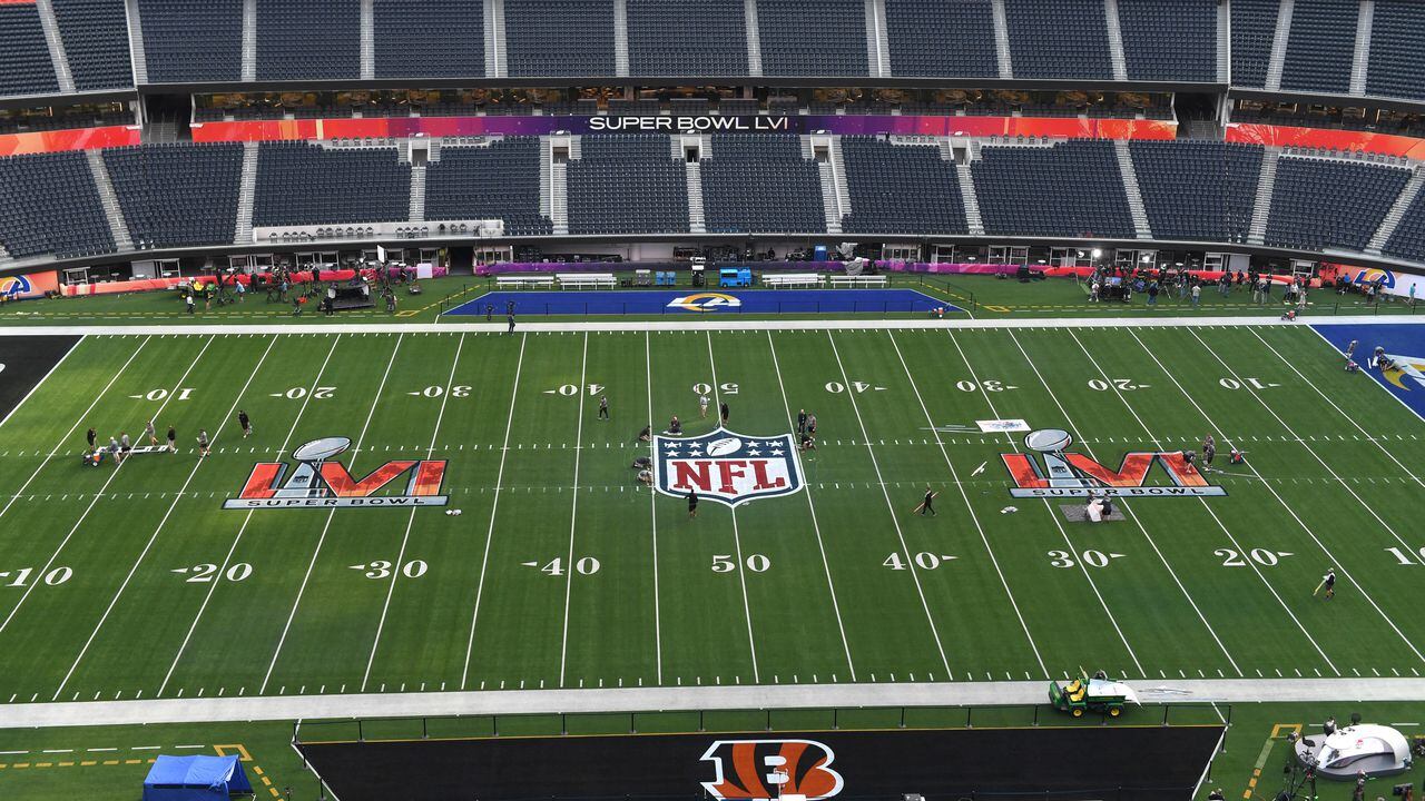 Workers prepare the field one day before Super Bowl LVI between the Los Angeles Rams and the Cincinatti Bengals at So-Fi Stadium in Inglewood, California on February 12, 2022. (Photo by VALERIE MACON / AFP)
