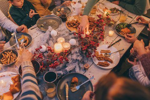 Photo of a multi generation family during Thanksgiving dinner, spending time together over eaten food and messy plates