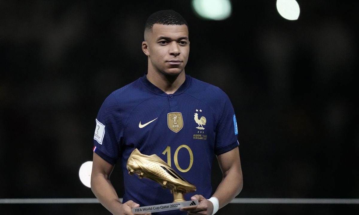 France's Kylian Mbappe holds the Golden Boot award for top goalscorer of the tournament after the World Cup final soccer match between Argentina and France at the Lusail Stadium in Lusail, Qatar, Sunday, Dec. 18, 2022. Argentina won 4-2 in a penalty shootout after the match ended tied 3-3. (AP/Martin Meissner)
