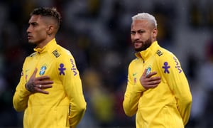 SAO PAULO, BRAZIL - NOVEMBER 11: (L-R) Raphinha and Neymar Jr. of Brazil line up for the national anthem prior to a match between Brazil and Colombia as part of FIFA World Cup Qatar 2022 Qualifiers at Neo Quimica Arena on November 11, 2021 in Sao Paulo, Brazil. (Photo by Alexandre Schneider/Getty Images)