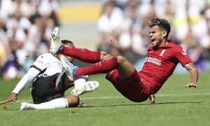 Liverpool's Luis Diaz, right, is tackled by Fulham's Kenny Tete vie for the ball during the English Premier League soccer match between Fulham and Liverpool at Craven Cottage stadium in London, Saturday, Aug. 6, 2022. (AP Photo/Ian Walton)