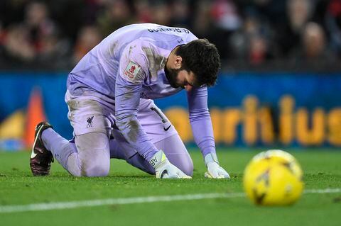 Liverpool's Brazilian goalkeeper Alisson Becker reacts after making a mistake that allowed Wolverhampton Wanderers' Portuguese striker Goncalo Guedes (not seen) to score his team's first goal during the English FA Cup third round football match between Liverpool and Wolverhampton Wanderers at Anfield in Liverpool, north-west England on January 7, 2023. (Photo by Oli SCARFF / AFP) / RESTRICTED TO EDITORIAL USE. No use with unauthorized audio, video, data, fixture lists, club/league logos or 'live' services. Online in-match use limited to 120 images. An additional 40 images may be used in extra time. No video emulation. Social media in-match use limited to 120 images. An additional 40 images may be used in extra time. No use in betting publications, games or single club/league/player publications. /