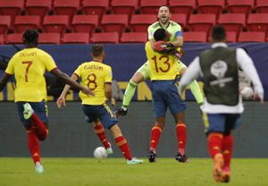 Colombia's Yerry Mina (C) lifts Colombia's goalkeeper David Ospina after defeating Uruguay in the penalty shootout of their Conmebol 2021 Copa America football tournament quarter-final match at the Mane Garrincha Stadium in Brasilia, Brazil, on July 3, 2021. (Photo by SILVIO AVILA / AFP)