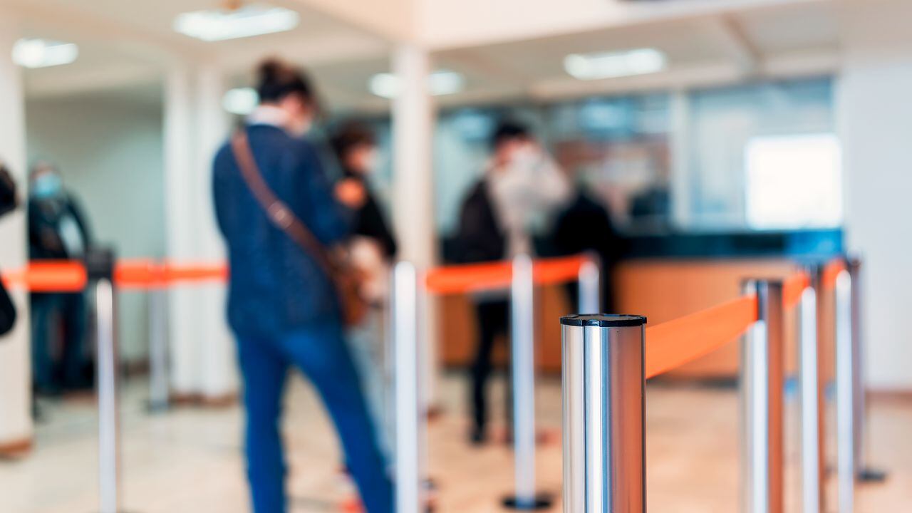 row of people to the bank teller cashier defocused background