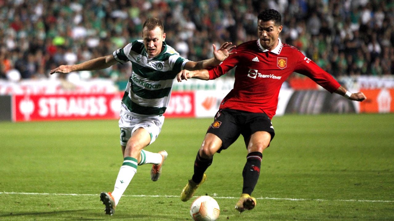 Manchester United's Cristiano Ronaldo, right, and Omonia's Paris Psaltis fight for the ball during the Europa League group E soccer match between Omonia and Manchester United at GSP stadium in Nicosia, Cyprus, Thursday, Oct. 6, 2022. (AP/Maria Karadjias)