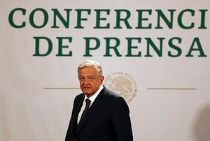 FILE - In this April 20, 2021 file photo, Mexican President Andres Manuel Lopez Obrador arrives to give his daily, morning news conference at the presidential palace in Mexico City. Lopez Obrador said on Aug. 5, 2021 that Mexico has accepted to host talks between representatives of the Venezuelan government and its opposition, with Norway as the mediator. (AP Photo/Fernando Llano, File)