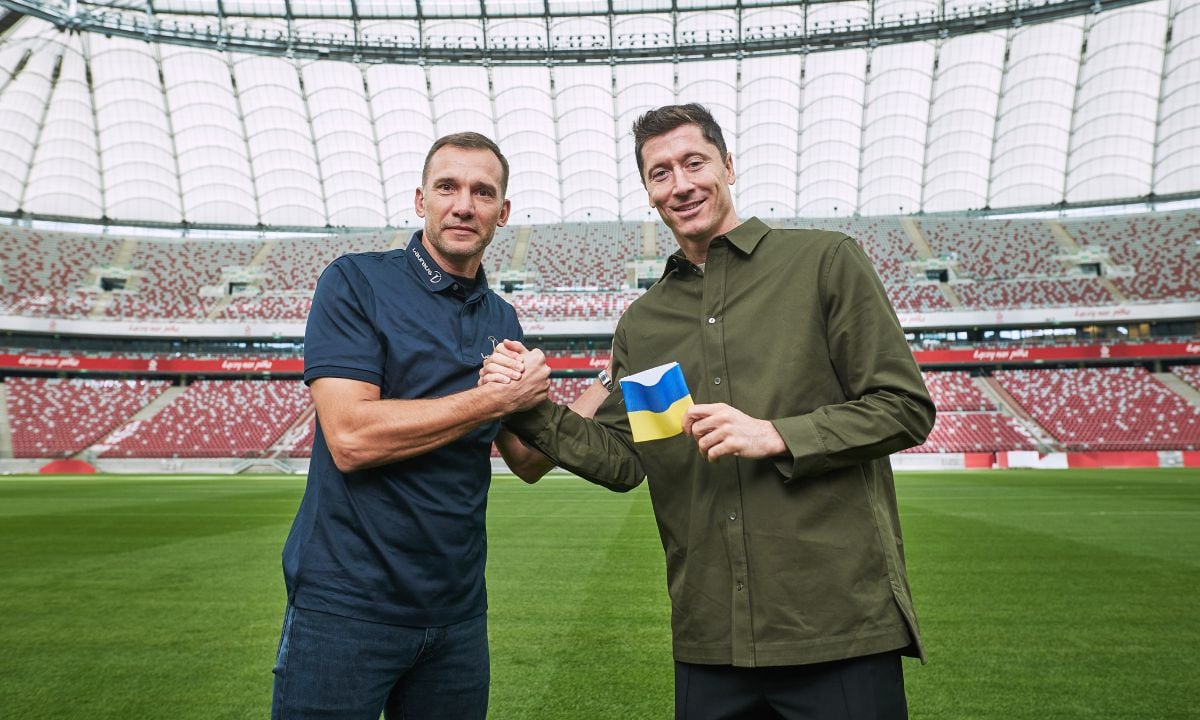 WARSAW, POLAND - SEPTEMBER 20: Poland captain Robert Lewandowski receives a Ukraine armband from Laureus Ambassador Andriy Shevchenko and pledges to carry it to FIFA World Cup 2022 Qatar at PGE Narodowy Stadium on September 20, 2022 in Warsaw, Poland. (Photo by Joosep Martinson/Getty Images for Laureus)